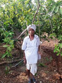 Portrait of smiling senior man standing in farm