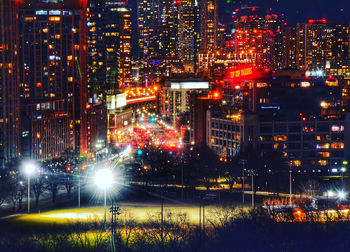 High angle view of illuminated buildings in city at night