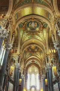 Low angle view of ornate ceiling in temple