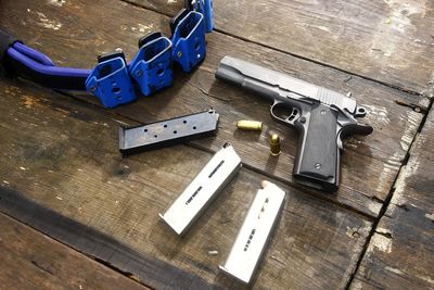 High angle view of handguns on wooden table