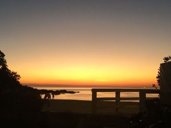 Scenic view of sea against clear sky during sunset