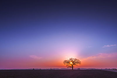 Scenic view of land against sky during sunset