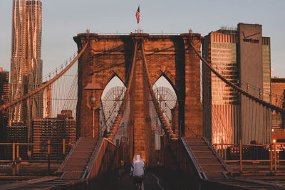 Rear view of woman walking towards bridge