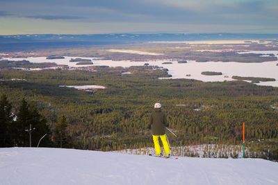 Scenic view of snow covered field against sky