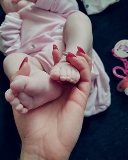 Close-up of father holding baby hand