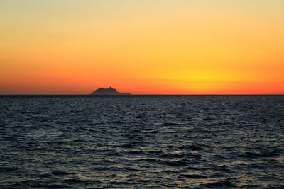 Scenic view of sea against romantic sky at sunset