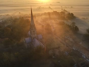 High angle view of buildings in city during sunset