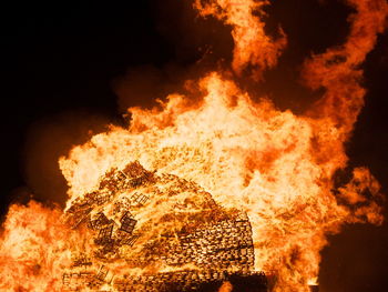 Close-up of fire against sky at night