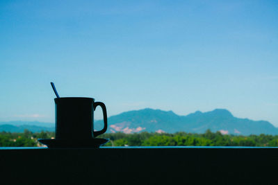 Close-up of coffee against clear blue sky