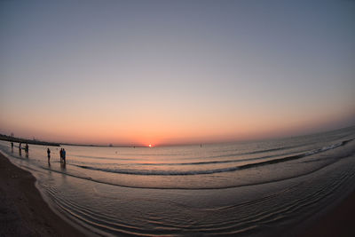 Scenic view of calm sea at sunset