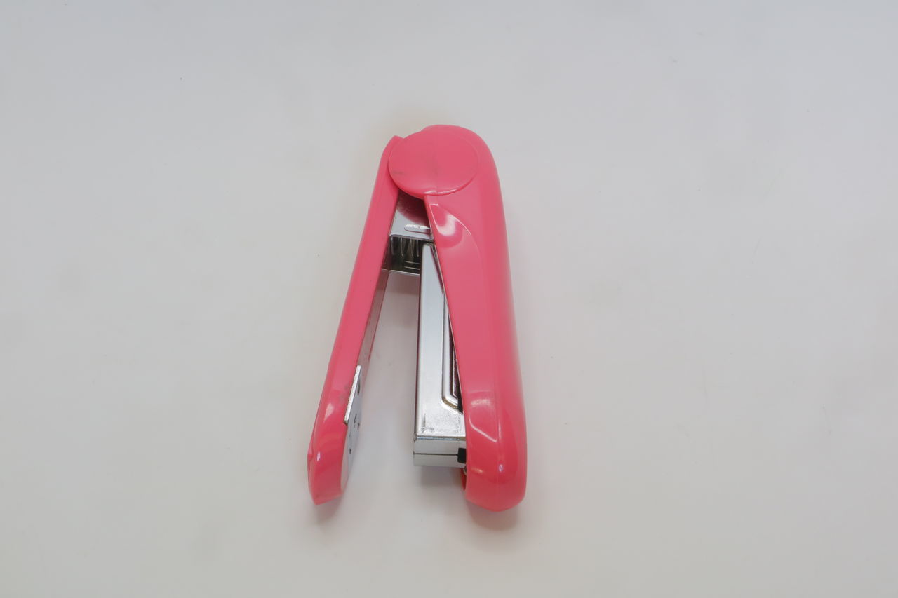 CLOSE-UP OF RED TELEPHONE OVER WHITE BACKGROUND