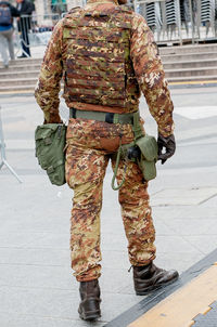 Low section of man standing on street