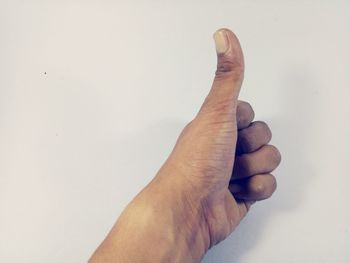 Close-up of human hand against white background