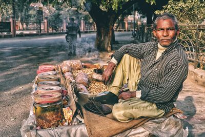 Portrait of smiling man sitting outdoors