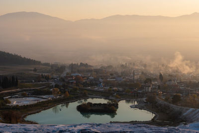 High angle view of buildings in city during sunset