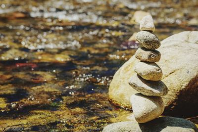 Close-up of stack of rocks by water