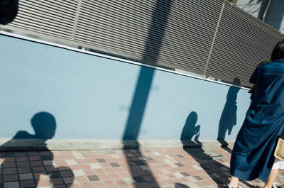 Close-up of woman standing against black background