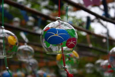 Close-up of decoration hanging on glass