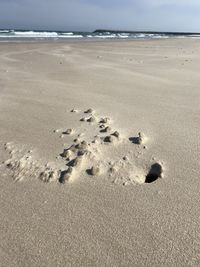 High angle view of footprints on beach