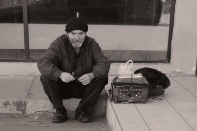 Man with dog sitting in winter