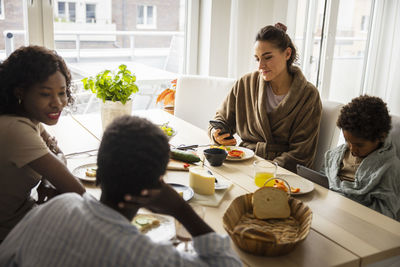 Mothers and sons eating breakfast