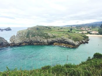 Scenic view of calm sea against cloudy sky