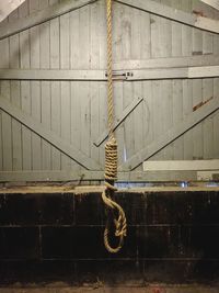 Rope tied up on metal wall