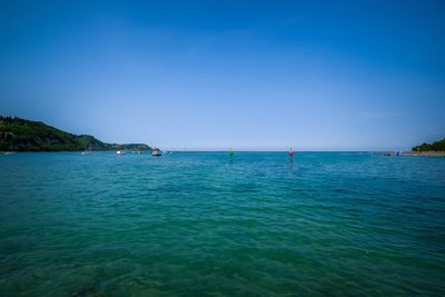 Scenic view of sea against clear blue sky