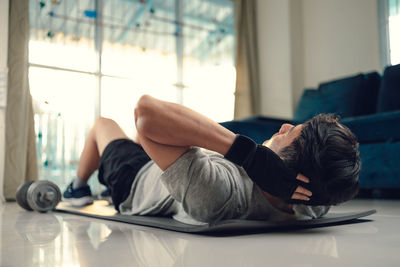 Low angle view of man exercising at home