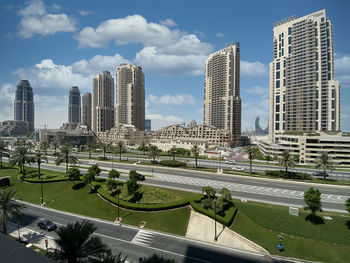 Aerial view of buildings in city against sky