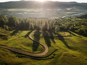 High angle view of road amidst trees on landscape