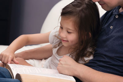 Midsection of woman reading book