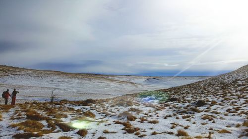 Scenic view of frozen  land against sky