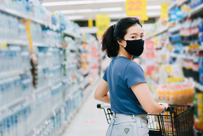 Young woman standing at store