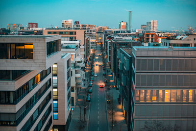 High angle view of illuminated buildings against sky at dusk