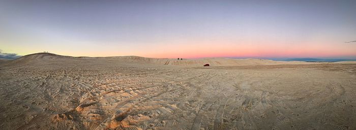 Scenic view of desert against sky during sunset