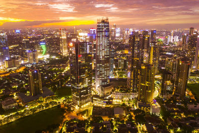 High angle view of city lit up at night