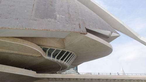Low angle view of bridge over building against sky