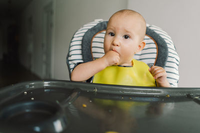 Little child with solid nutrition. baby girl eating food and mix vegetable plate