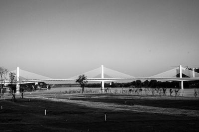 Bridge over field against clear sky