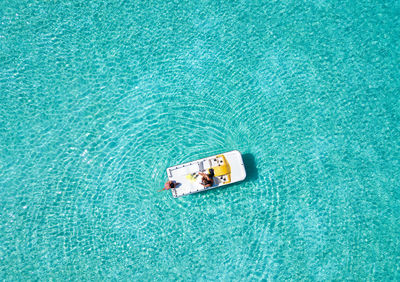 High angle view of men in boat on sea