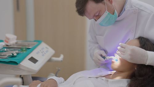 Midsection of doctor examining patient at clinic