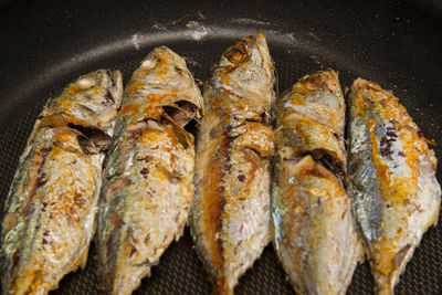 High angle view of fish on barbecue grill