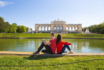 Residence in vienna, austria. girl and boy are sitting near the fountain