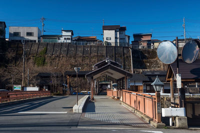 Shibu onsen bus station to visit town in valley against blue sky with japanese houses in yamanouchi,