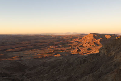 Scenic view of dramatic landscape against sky during sunset