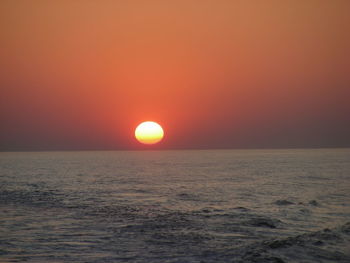 Scenic view of sea against orange sky