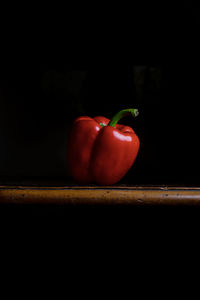 Close-up of strawberry on table against black background