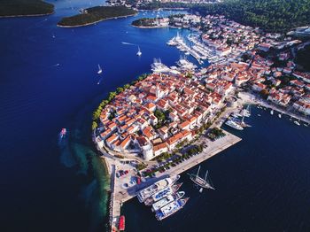 High angle view of cityscape by sea against sky