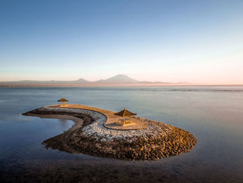 Scenic view of sea against clear sky during sunset